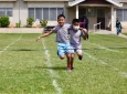 Text book demonstration of three legged race form.
